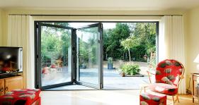 3 part bi folding door set in RAL 7021 used at the end of a lounge to bring light into the room and open out into the garden